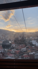 Cable car passenger films sunset aerial view of La Paz