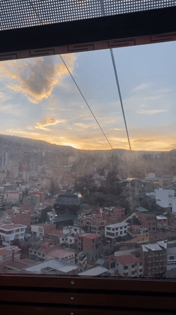 Cable car passenger films sunset aerial view of La Paz