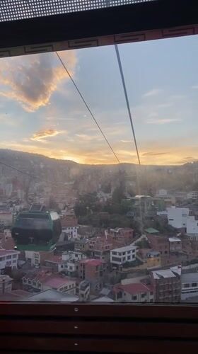 Cable car passenger films sunset aerial view of La Paz