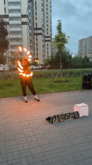 Fire spinning at dusk in a Sinyavino residential district