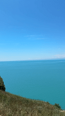 Coastal clifftop views with turquoise waters documented by witnesses
