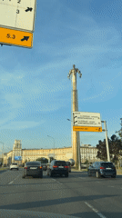 Traffic flows through Moscow streets near highway signage