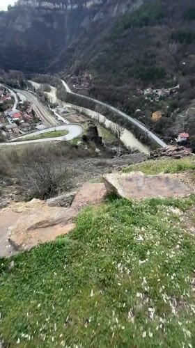 Visitor explores elevated viewpoint overlooking valley in Bov, Bulgaria
