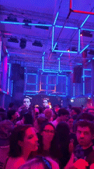 Paris nightclub features geometric neon lighting during crowded evening event