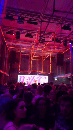 Paris nightclub features geometric neon lighting during crowded evening event