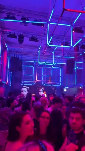 Paris nightclub features geometric neon lighting during crowded evening event