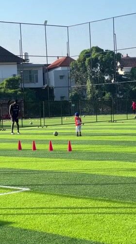 Soccer training session with coach and child in Denpasar