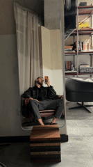 Man takes mirror selfie in burgundy chair, Yerevan
