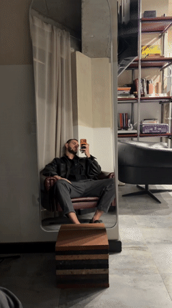 Man takes mirror selfie in burgundy chair, Yerevan