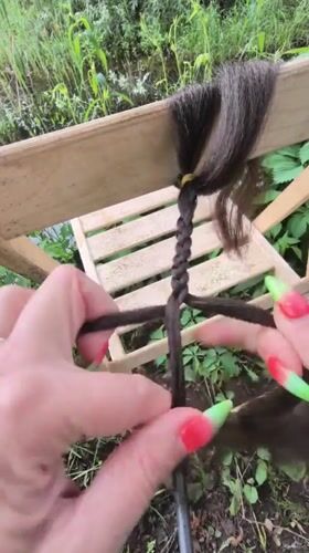 Hair braiding session documented in Russian garden setting
