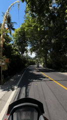 Motorcyclist encounters parked concrete mixer on Manggis road