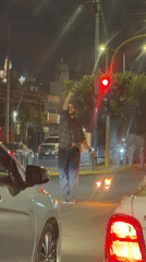 Man holds flaming torches in Cholula intersection at night