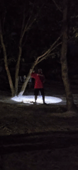 Night cleaning: Person sweeps outdoor area with headlamp in Denpasar