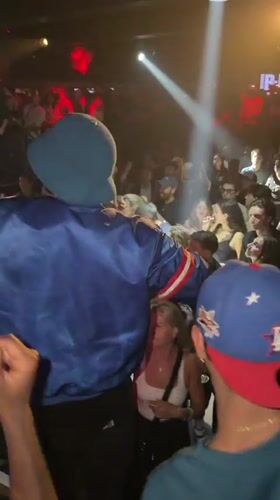 Person in blue jacket performs at Paris venue