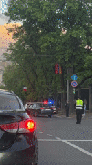 Police direct traffic at Yerevan intersection during evening hours