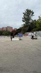 Skaters session a concrete skatepark in Almada on a cloudy morning.