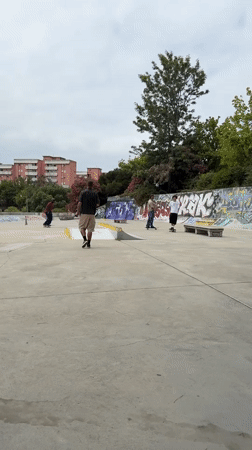 Skaters session a concrete skatepark in Almada on a cloudy morning.