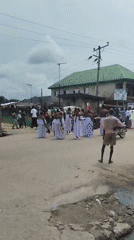 Traditional procession with white garments observed in Agbarha-Otor, Nigeria