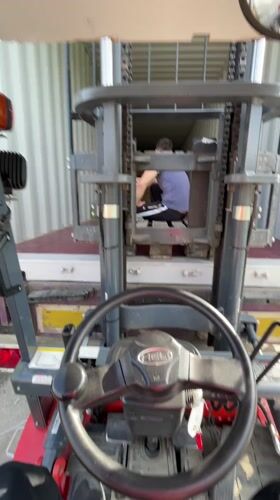 Forklift operations inside shipping container captured in Asenovgrad