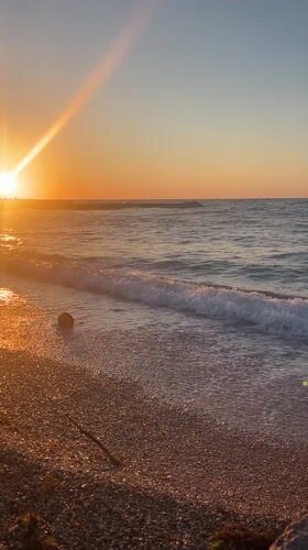 Sunset observed at Sevastopol beach with golden light, gentle waves
