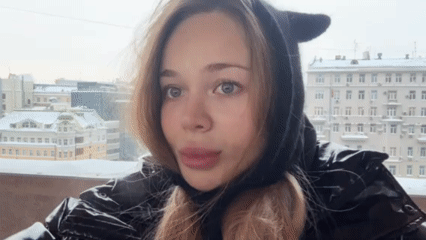 Morning selfie session: woman in cat-ear hoodie documented citywide
