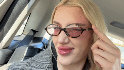 Woman in glasses photographed in car backseat in Belgrade