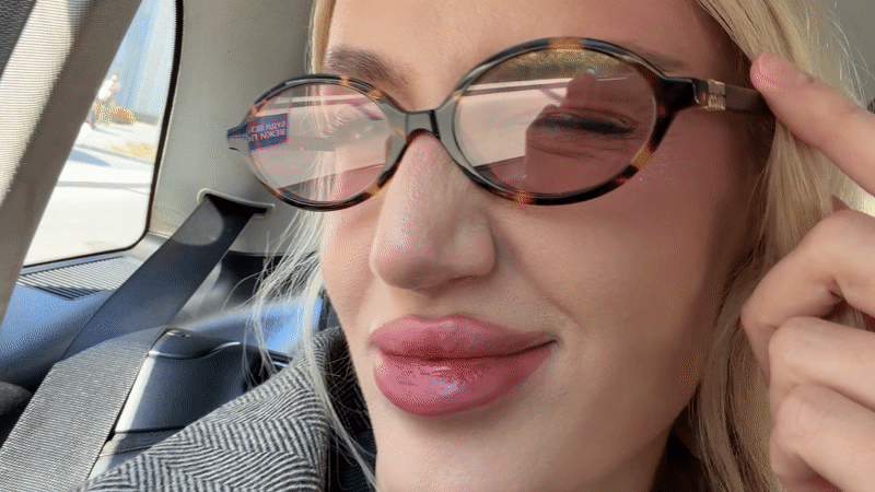 Woman in glasses photographed in car backseat in Belgrade