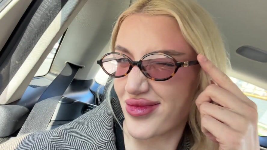 Woman in glasses photographed in car backseat in Belgrade