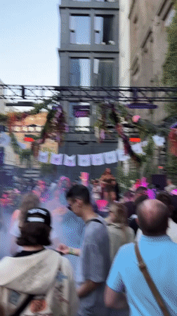 Moscow courtyard hosts afternoon dance party with 'DON'T PANIC' banners
