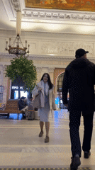 Woman twirls in ornate St. Petersburg station amid chandeliers