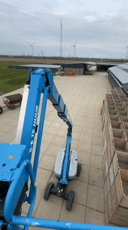 Rental boom lifts operate in commercial yard, Lelystad