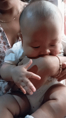 Mother and baby moments captured alongside sleeping cat in Indonesia