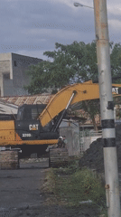 Excavator conducts roadwork in Lhokseumawe residential area