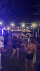 Nighttime outdoor party in Kuta with DJs and fire dancing