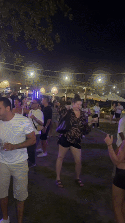 Nighttime outdoor party in Kuta with DJs and fire dancing