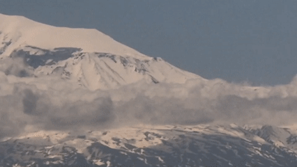 Snow-capped mountains observed from elevated urban position