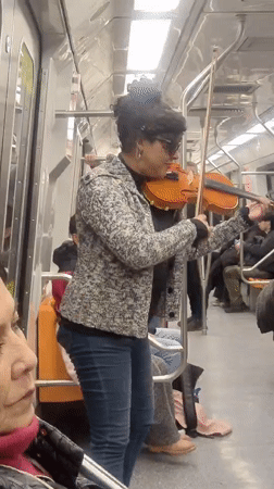 Live violin performance on the Santiago Metro