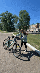Woman enjoys bike ride and bouncy castle in Birobidzhan park