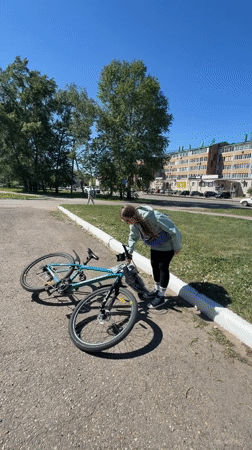 Woman enjoys bike ride and bouncy castle in Birobidzhan park