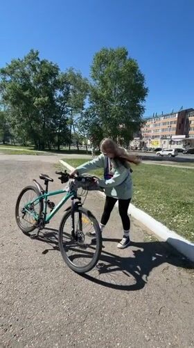 Woman enjoys bike ride and bouncy castle in Birobidzhan park