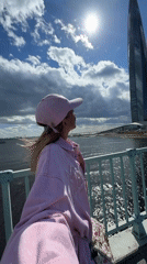 Tourist poses near Saint Petersburg's Lakhta Center skyscraper