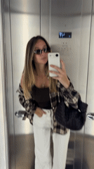 Woman in plaid shirt observed sitting in parked car