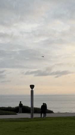 Lamppost observed near ocean under cloudy Dana Point sky