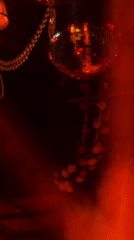 Disco ball reflects colored lights in dark Moscow room