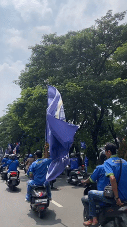 Mixed vehicle procession travels through Surabaya streets