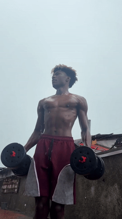 Man exercises outdoors in rain in Igboefon, Nigeria