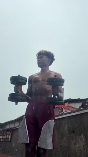 Man exercises outdoors in rain in Igboefon, Nigeria