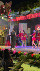 Outdoor concert in Porlamar with live vocals and red-clad dancers