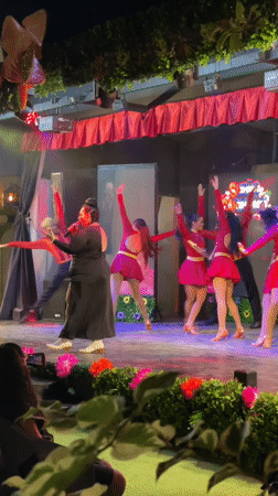 Outdoor concert in Porlamar with live vocals and red-clad dancers