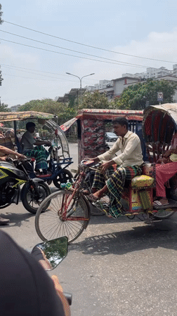 Morning rickshaw traffic observed in busy Dhaka street